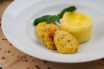 fish cutlets with mashed potatoes in a white plate
