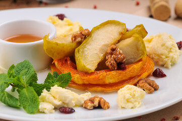 baked apples and pumpkin in a white plate
