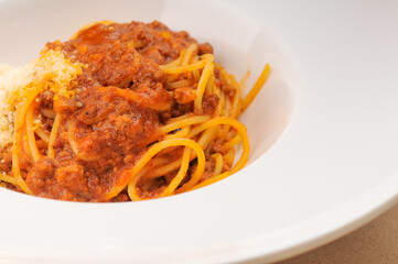 italian pasta with sauce in a white plate macro photo
