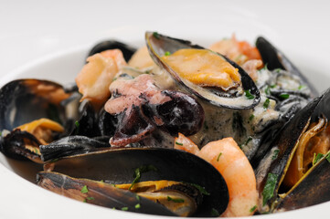 seafood mussels shrimp and octopus in a plate
