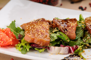 salad with tuna and salmon sprinkled with sesame
