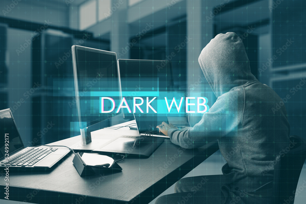 Poster Hacker at desktop using computers with abstract creative digital text hologram on blurry office interior background. Dark web, hacking, technology and ai concept.