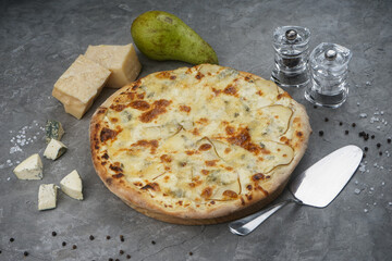 pizza with pear and cheese on a gray background with cheese
