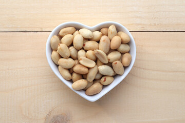 salted peanuts in a heart shaped bowl.