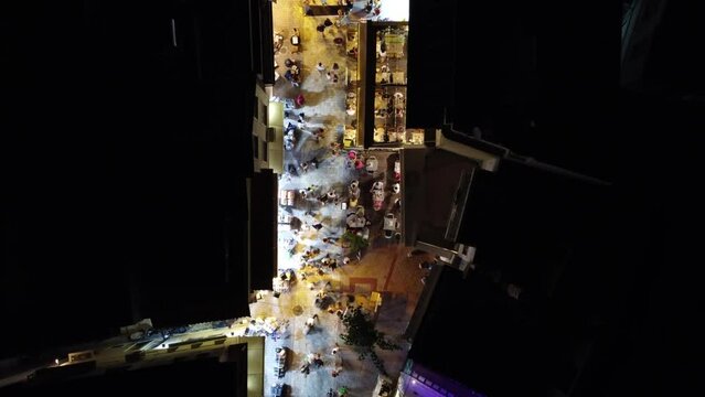 The city center of Skiathos at night, Greece, filmed from above