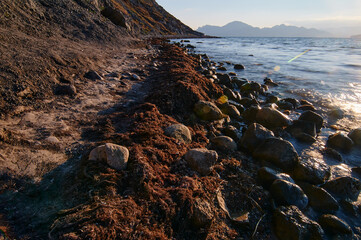 Landscape with sea shore, waves and stones on the rocks beach.