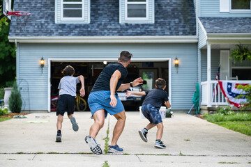 Fototapeta premium Air Force service member trains with his sons in a morning workout in preperation for a PT fitness test.