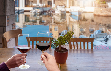 couple holding wine glasses, close up. Aspat Marina