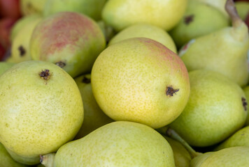 Green red new harvest pears for sale at city market
