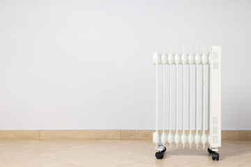 Concept of heating season, modern electric heater in room
