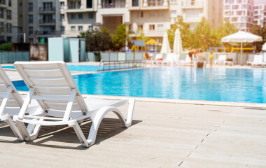 Obraz na płótnie Canvas sun loungers by the pool, front view