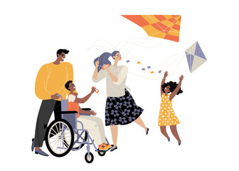 Cute family with son in wheelchair flying kites.