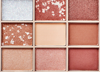 Fototapeta premium Eyeshadow colorful shades palette in beige tones close-up. Beauty abstract background