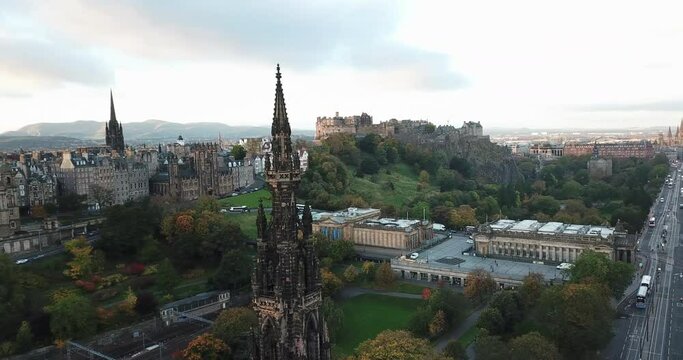 Rare drone shot of Edinburgh city above Scott Monument. The clip pans around the monument giving a panoramic view of the city at sunrise.