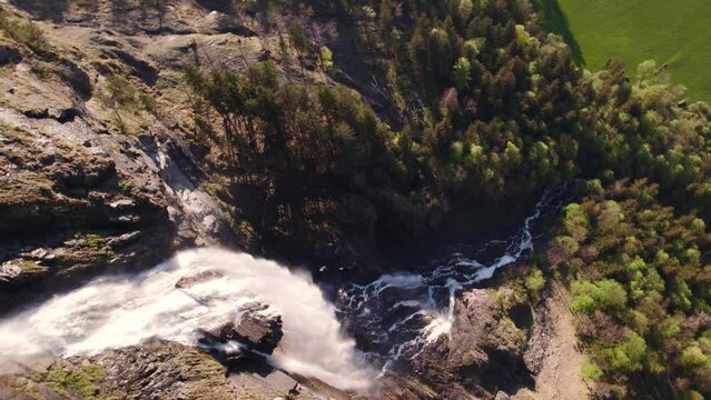 aerial drone footage top down view rotating counterclockwise around Fallbach, a picturesque waterfall in Grindelwald in the Swiss Alps
