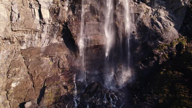 aerial drone footage pushing in at the bottom of a spectacular waterfall in Grindelwald in the Swiss Alps