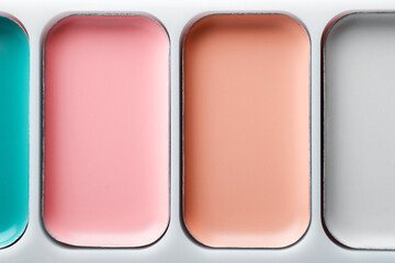 Colorful concealers palette close-up. Beauty make up abstract background