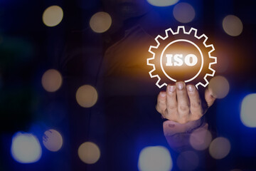 A businessman holding the ISO certificate icon, ISO processing step bokeh light, standard quality document control for organization and industry management products, copy space for design or text