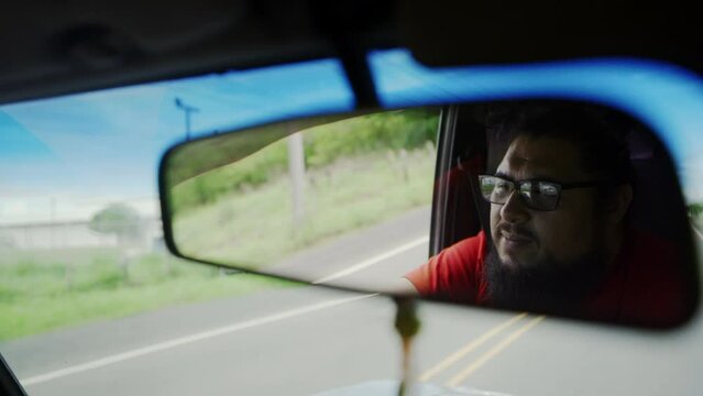 latino america Costa Rica driving on the highway road rear view mirror view of touristic driver