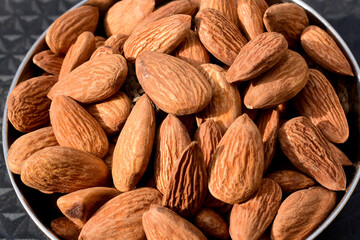 Almonds on wooden table background. Close up