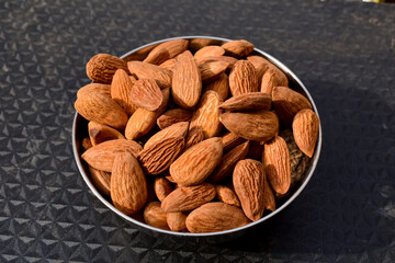Almonds on wooden table background. Close up