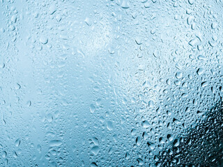 Water drops on glass background texture blue	
