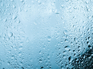 Water drops on glass background texture blue