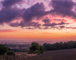 Fototapeta na wymiar Dramatic August dawn sky from the North's Seat Hastings Country Park East Sussex in the south east of England UK