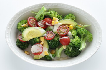 Avocado, cherry tomato, broccoli and sweet corn salad