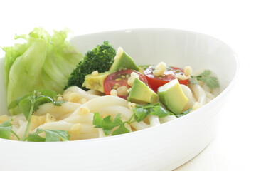 Japanese fusion food, broccoli and cherry tomato with avocado cold udon noodles for Summer cuisine 