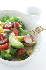 Avocado, cherry tomato, broccoli and sweet corn salad