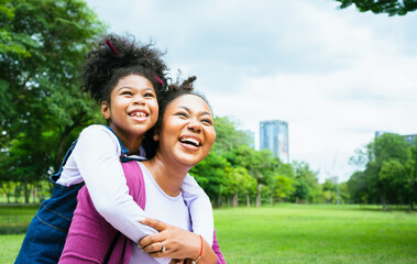 Happy african american mother having fun with her daughter outdoor - Family and love concept.Mother day celebration.African Family with black hiar Happiness Holiday Vacation Activity Concept.