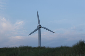 old broken abandoned wind turbine on the beach