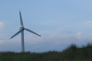 old broken abandoned wind turbine on the beach