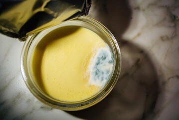 Open creme brulee package with mold inside - fast Perishable food