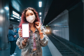 Asian girl wears a facial respiratory mask during the Covid-19 coronavirus pandemic and showing...