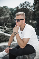 Young stylish Nordic blonde guy, portrait of modern youth. Confident boy with stylish clothes and accessories