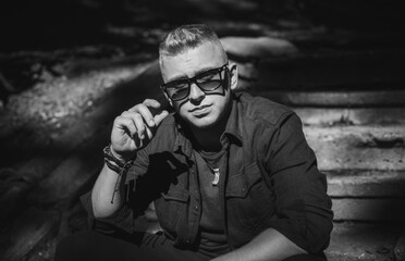 Young stylish Nordic blonde guy, portrait of modern youth. Confident boy with stylish clothes and accessories