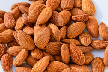 Almonds on wooden table background. Close up