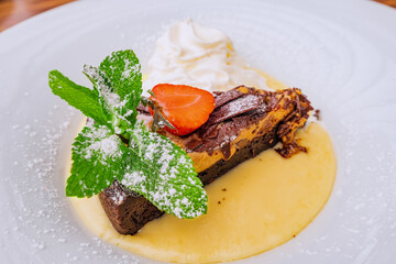 Cake with strawberries, mint and whipped cream as a concept of an unhealthy diet with fast carbohydrates that can lead to diabetes and other digestive disorders.
