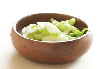 chopped celery in wooden bowl with copy space for cooking ingredient