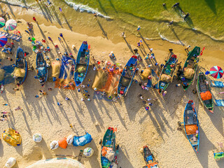 Top view of Fisherman casting his net at the sunrise or sunset. Traditional fishermen prepare the...