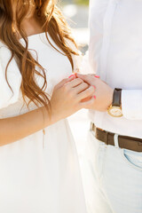 The thrilling moment of a marriage proposal at sunset. Details. Hands of a couple in love with a wedding ring