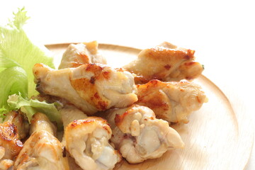 Barbecue chicken drumsticks on wooden plate with copy space