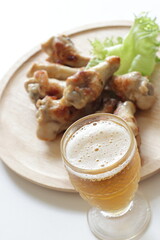 Barbecue chicken drumsticks on wooden plate with copy space