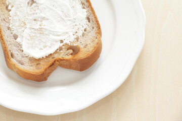 Cream cheese and walnut bread on white plate for breakfast 