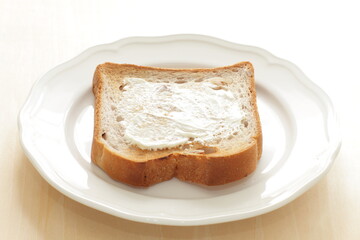 Cream cheese and walnut bread on white plate for breakfast 