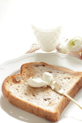 Toasted walnut bread on white dish with copy space