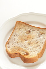 Toasted walnut bread on white dish with copy space