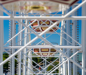 Image with white structure from Ferris wheel itself in amusement park